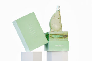 Green box for perfume with perfume bottle secured inside by a fitment.